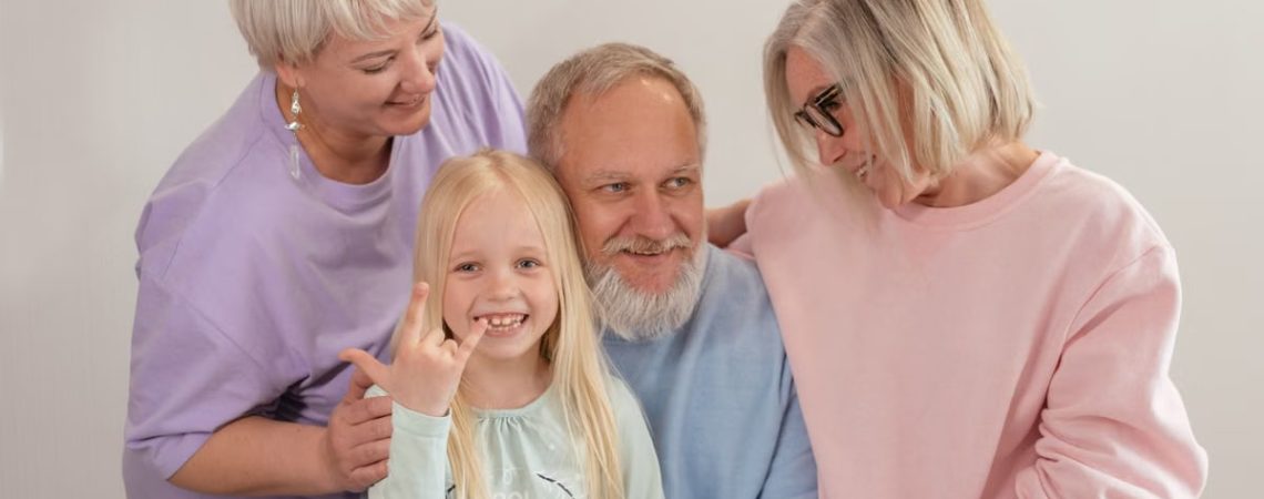 A joyful multigenerational family poses and smiles together indoors, showcasing love and togetherness.
